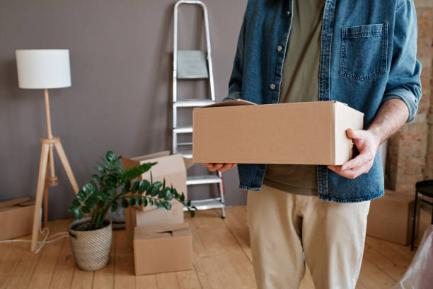 istock Horizontal shot of unrecognizable young man wearing casual clothes bringing boxes with things to new apartment 1361688404