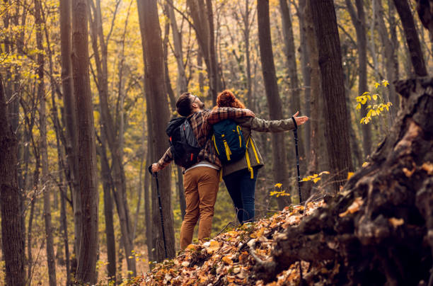 istock Young couple with backpack hiking in forest. 1361689597