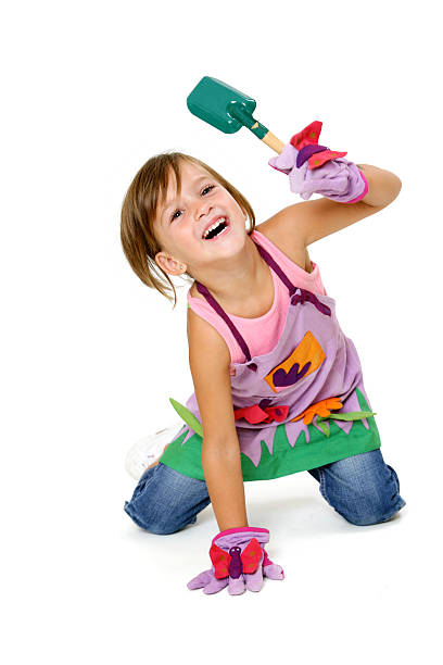 istock girl in garden clothes with tool 136169302