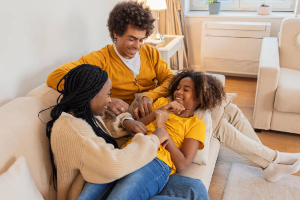 istock Mom and dad tickle the daughter 1361695554