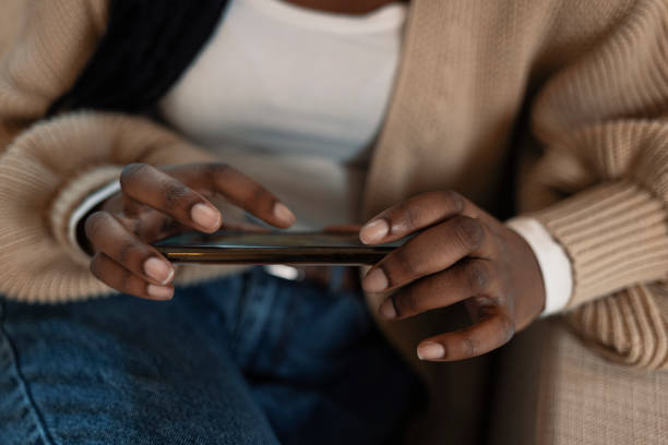 istock African young woman is typing on touch screen mobile phone 1361697142