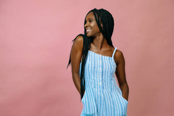 african american woman looking away and smiling african american woman looking away and smiling jumpsuit stock pictures, royalty-free photos & images