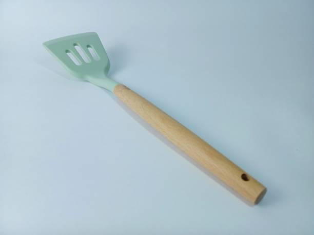 istock green wood spatula on white background 1361697962