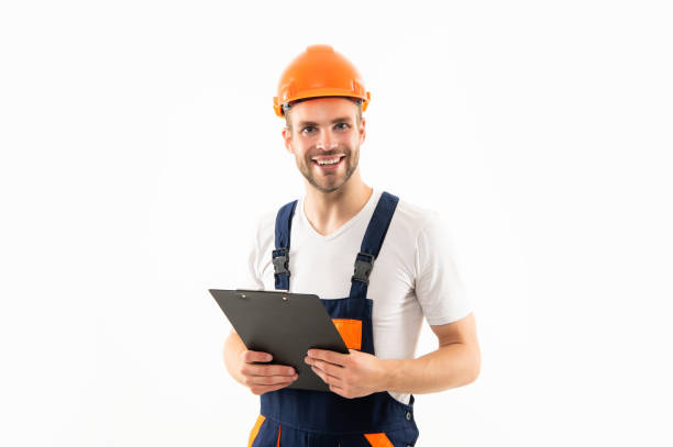 istock cheerful man in hardhat holding clipboard isolated on white background, expert 1361700140