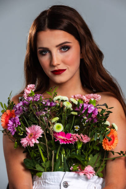 istock Lovely woman covered with roses 1361708523