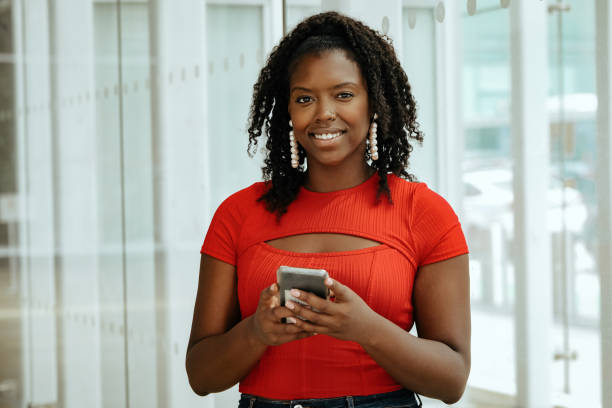 istock smiling african american woman using smartphone 1361709589