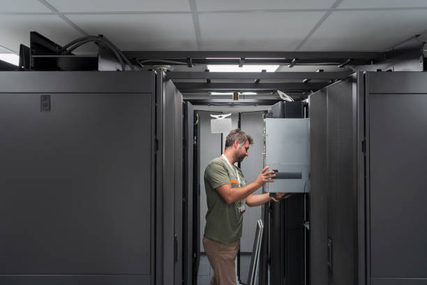 istock IT engineer working In the server room or data center The technician puts in a rack a new server of corporate business mainframe supercomputer or cryptocurrency mining farm. 1361711097