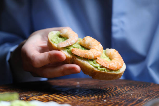 istock Making shrimp and avocado sandwiches 1361711360