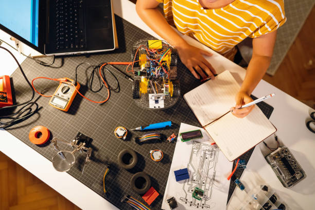 istock Unrecognizable female STEM student working late at night on her prototype of autonomous self-driven robotic car 1361713197