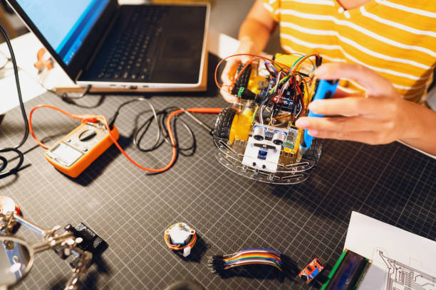 istock Dedicated unrecognizable female robotic engineer, making the prototype of autonomous self-driven robotic car with sensors 1361713283