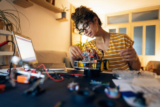 istock Proud female robotic engineer, successfully connected her robotic car prototype with open-source hardware and software software platform 1361713422