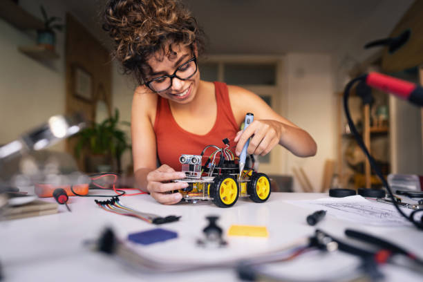 istock Excited female robotic engineer, feeling enthusiastic, while finishing her prototype of a self-driven robotic car 1361713601