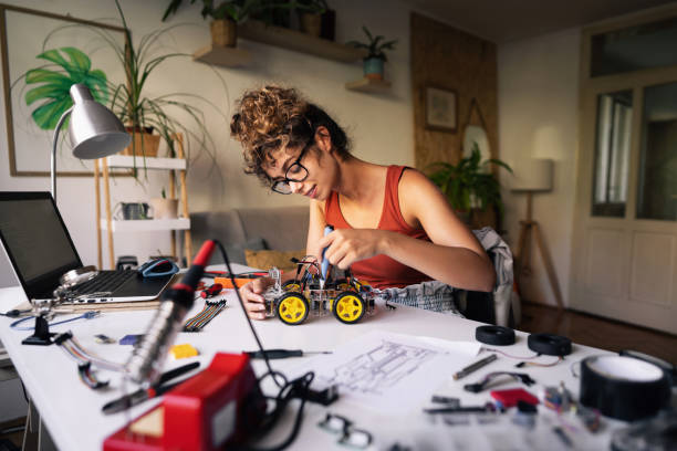 istock From her creative home office, a female robotic engineer student adjusting parts of a robotic car with a screwdriver 1361713614