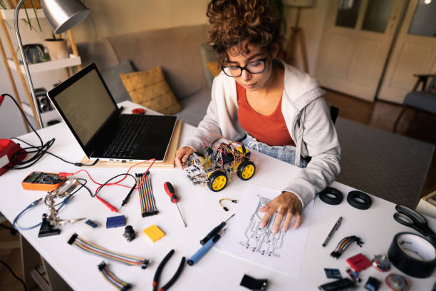 istock From her messy home workshop, female engineer, following the steps from the sketch while adjusting robotic car 1361713754