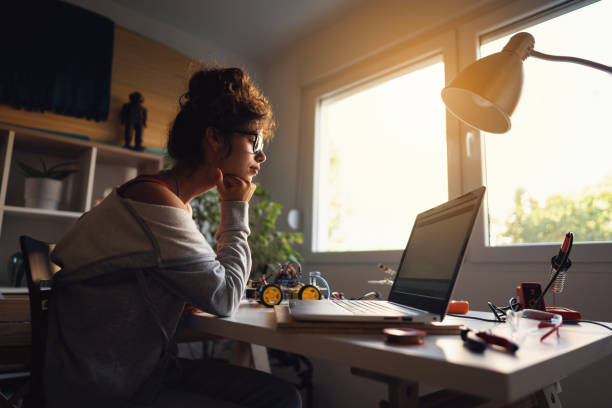 Female engineer and programmer, watching an online event about new engineering themes, to improve her knowledge in robotic engineering
