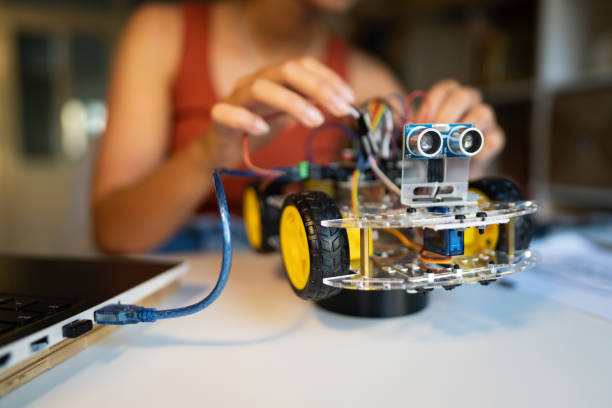 istock Unrecognizable STEM student adjusting prototype of autonomous self-driven robotic car with sensors 1361714765