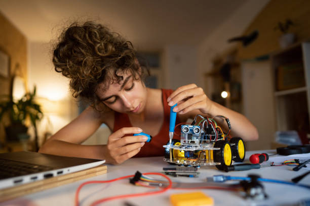 istock Programmer and engineer, late at night improving the prototype of the robotic car she working on 1361714857