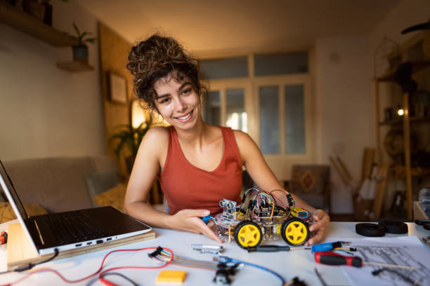 istock Innovative female robotic engineer, successfully finished her prototype of robotic car 1361714964