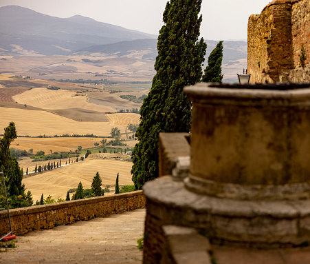 View of an old village looking the countryside with cypresses in Tuscany, Italy.