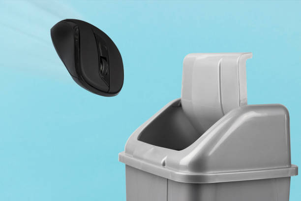 istock computer mouse goes in the trash, the notion of refusing to work in an office, losing a cybersport or game, refusing to work at a computer 1361720112