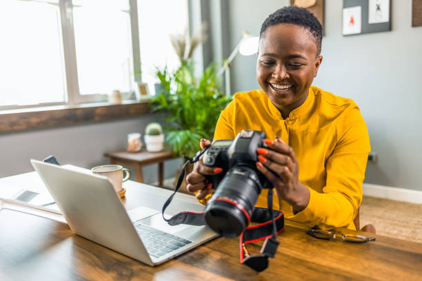 istock Happy young photographer holding a dslr camera 1361723027