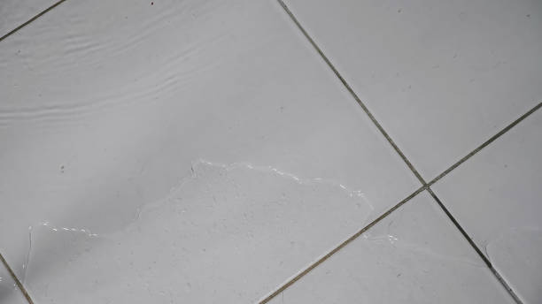 istock Flood water flows over white ceramic tile floor in bathroom 1361723158