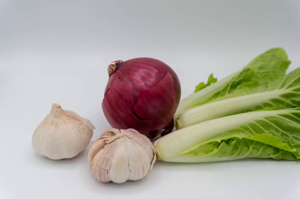 Scenic photography of a combination of vegetables. Fresh chard, dark red onions, pink garlic, a healthy vegetable food ensemble.Purple Onion Scenic photography of a combination of vegetables. Fresh chard, dark red onions, pink garlic, a healthy vegetable food ensemble.Purple Onion cabbage coral photos stock pictures, royalty-free photos & images