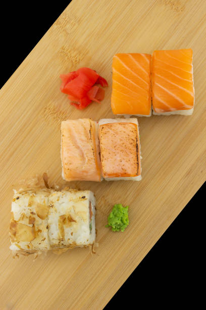 istock Set of sushi maki rolls on wooden board 1361726833