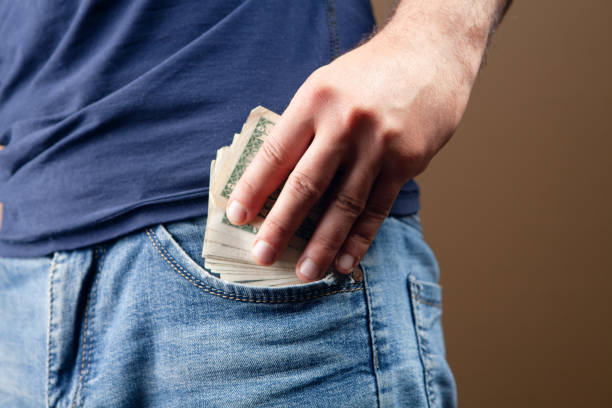 istock a man puts money in his pocket 1361728092