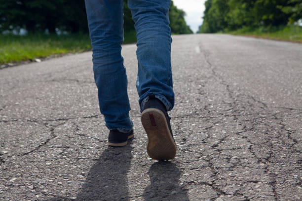 istock a man walks on an asphalt road 1361728204
