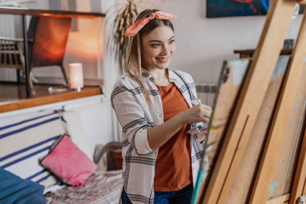 istock Painter enjoys creating a new work of art in studio 1361729094