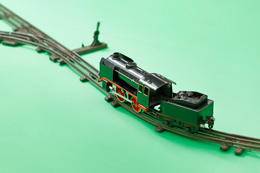 Model of a freight train running on tracks. Children's transportation games.