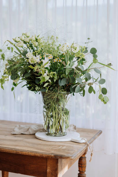 istock A styled vase full of greenery on a wooden sideboard 1361729245