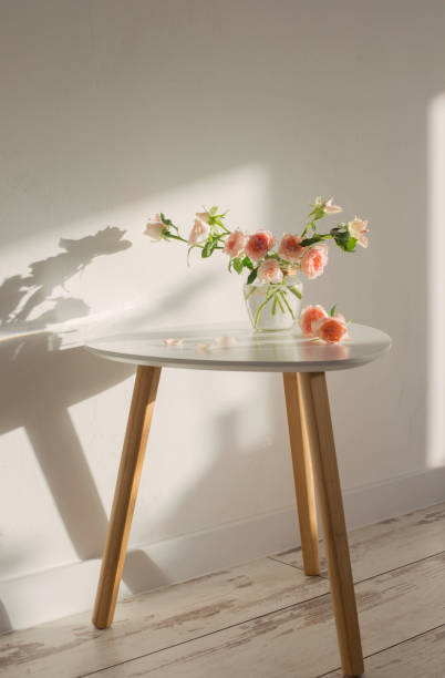 istock pink roses in glass jar on white modern table on background white wall 1361729533
