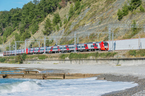 istock Passenger train moves along Black sea coast. 1361730867