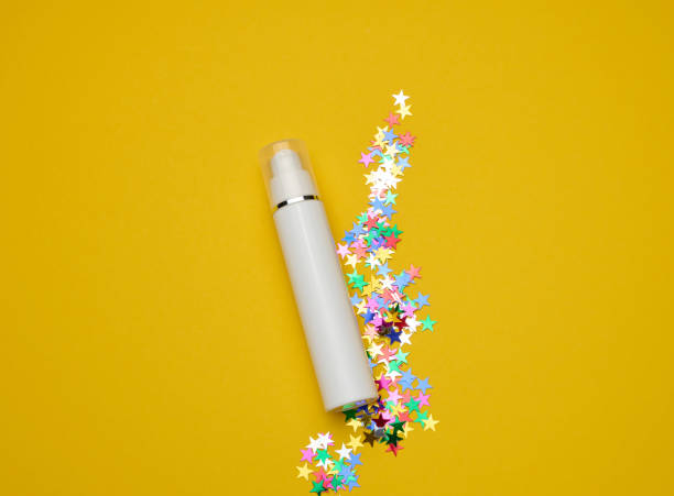 istock white plastic cosmetic bottle with dispenser and transparent cap on yellow background. Packaging for cream, fluid and gel 1361731203