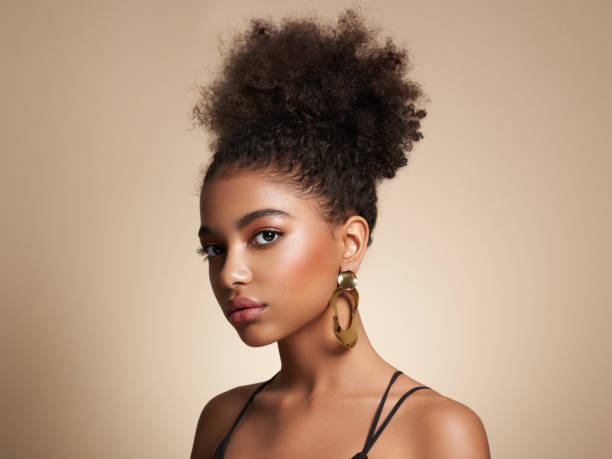 Beauty portrait of African American girl with afro hair Beauty portrait of African American girl with afro hair. Beautiful black woman. Cosmetics, makeup and fashion costume jewelry stock pictures, royalty-free photos & images