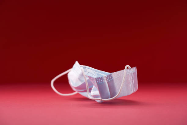 istock used face mask on the red background 1361732468
