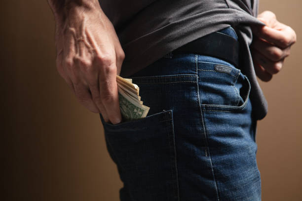 istock man puts money in his back pocket 1361733873