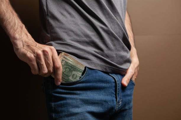 istock a man puts money in his pocket 1361733874