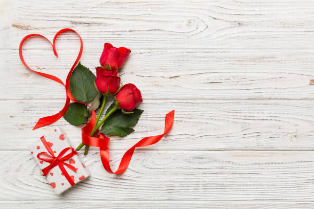 istock Valentine day composition with rose flower and red heart on table. Top view, flat lay, copy space Holiday concept 1361735486