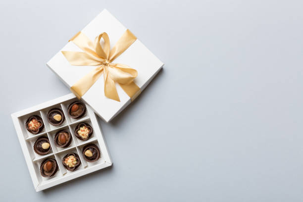 istock White box with chocolates candies and golden tape. top view with copy space 1361735538