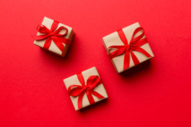 istock Valentine day composition Background: red gift box with bow and heart. Christmas present. View from above. Holday greeting card 1361735594