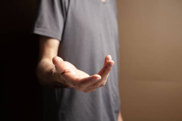 istock man shows open palm on brown background 1361737997