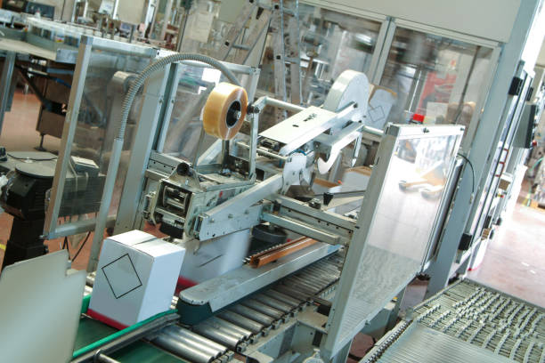istock Automatic industrial packaging, boxing and closing of cartons 1361739822
