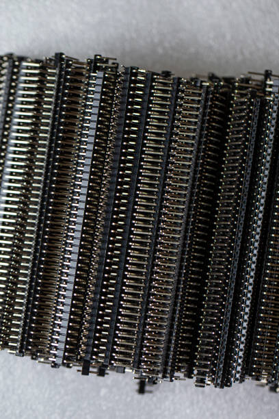 istock Microelectronics Concepts. Macro Shot of Long Straight PCB Connectors or Terminal Blocks Placed Bulk Over White 1361742903