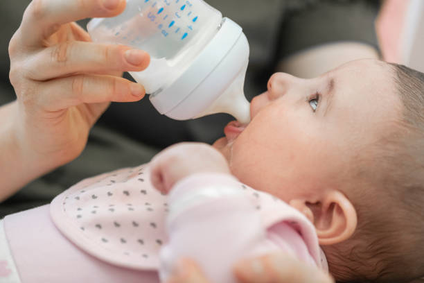 istock Baby Drinking with Baby Bottle 1361743278