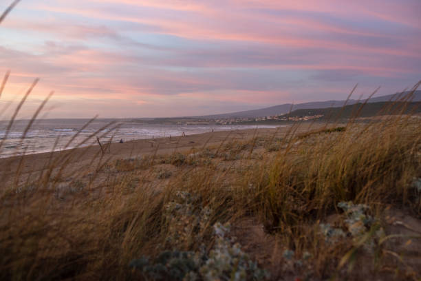 View of a dramatic sunset sky along the beach in Sardinia, Italy.