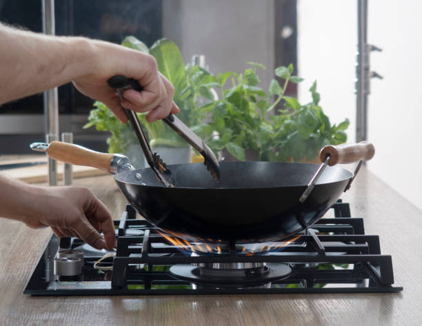 istock Frying pan on a gas stove. Chef controls the cooking process 1361746597