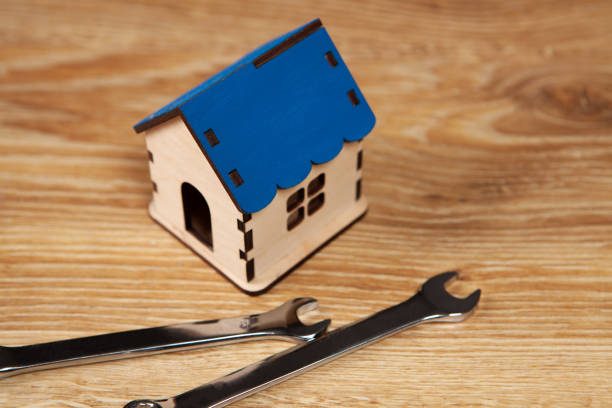 istock wrenches and house on the table 1361747171